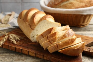 Cut bread loaf and spikes on wooden table, closeup