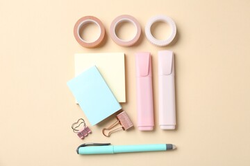 Pen and other stationery on beige background, flat lay