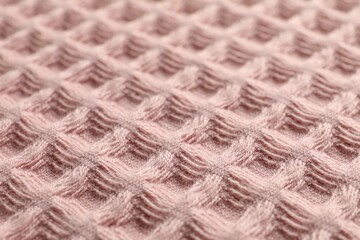 Clean pink waffle towel as background, closeup