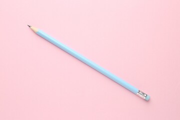 One graphite pencil on pink background, top view
