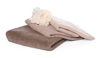 Soft towels and peony flower isolated on white