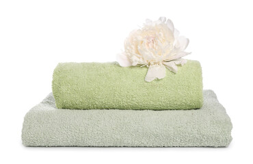 Soft towels and peony flower isolated on white