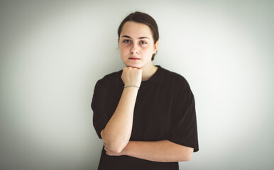 15 years old teen girl on studio gray look sad