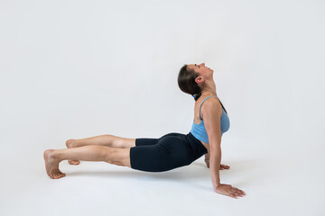 Obraz premium Caucasian female trainer doing stretching exercises isolated on white