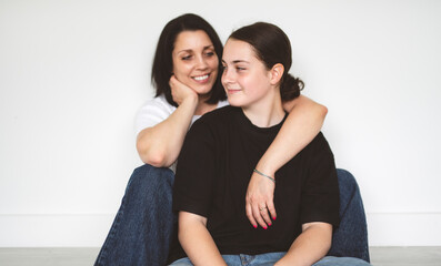 mother with teen girl, sit on the floor