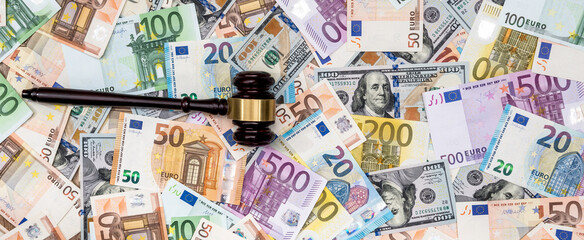 hammer of the judge on background of dollar and euro bills