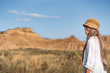 Tourist smiling and enjoying the bardenas reales desert landscape in spain