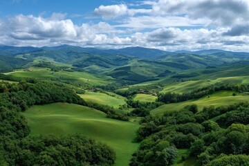Rolling green hills and lush forests under a cloudy sky