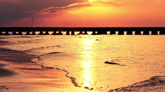 slow motion of sea waves lapping the beach at sunrise
