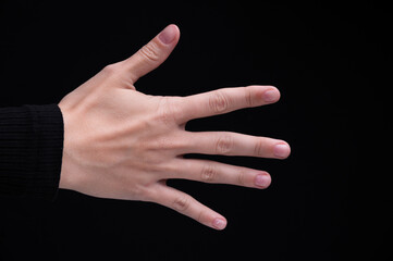 Caucasian woman's female hand back side on black background