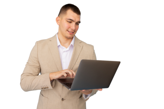 Young businessman dressed in a suit and white shirt, focused on typing on a laptop against a transparent background