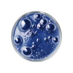 Petri dish with a vibrant blue liquid, various sized bubbles