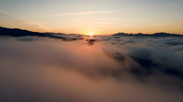 Sunrise Above Clouds Illuminating Mountain Peaks in Breathtaking Scenic View