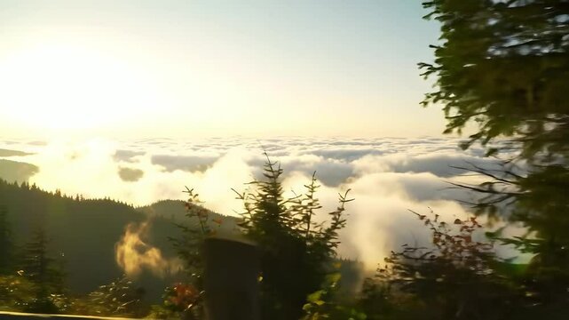 Golden Sunrise Over Mountain Peak Above Clouds with Warm Horizon Light