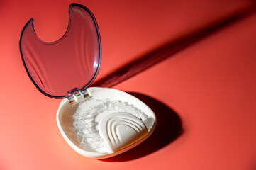 Transparent aligners and storage case. Invisible braces. Clear teeth straighteners. plastic bracers ready to use