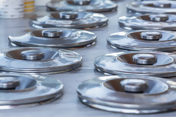 Shiny metal ice cream containers at traditional Turkish street food stand, aligned on counter