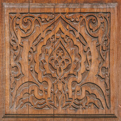 Traditional Uzbek wooden ornament with intricate floral and geometric carvings