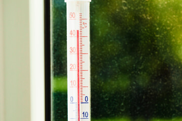 Thermometer shows high temperature during heat waves outside.