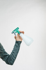 Hand holds spray bottle