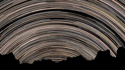 Star trails over silhouette mountain range