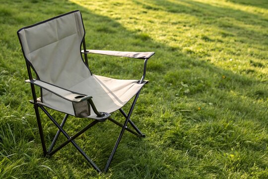 Outdoor camping chair mockup on grass with editable fabric