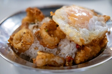 Stir fried crispy squid with salt and chili, served with rice and fried egg