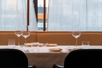 Set up table with spoon, fork, knife and plate in the restaurant