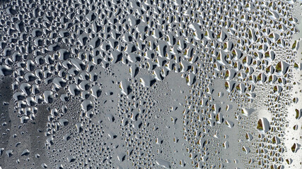 background, unusual, abstract. drops of morning dew, condensation on the glass. wet glass. water drops close-up. beautiful background for text. Spray cool water on the glas, condensate