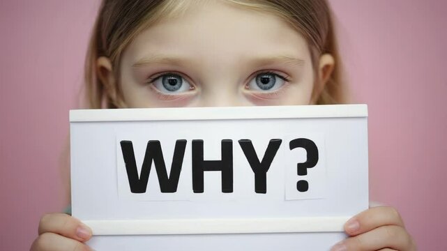 Close-up of young girl holding why text sign, questioning meaning, injustice or emotional confusion