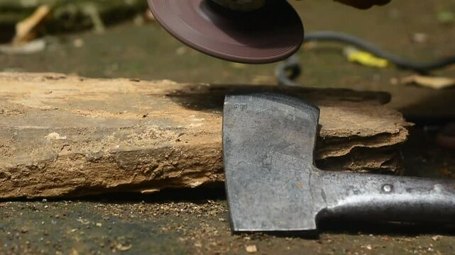Isolated close up of chef knife sharpening, honing and stropping process by  a skilled craftsman. Vintage old school craftsman at work in grange shop showing true professional skills.