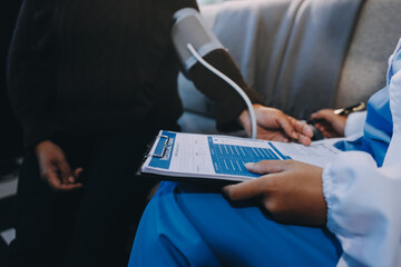Doctor using Blood pressure monitor and stethoscope checking measuring arterial blood pressure on...