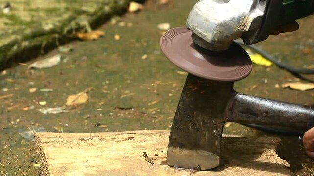 Isolated close up of chef knife sharpening, honing and stropping process by  a skilled craftsman. Vintage old school craftsman at work in grange shop showing true professional skills.