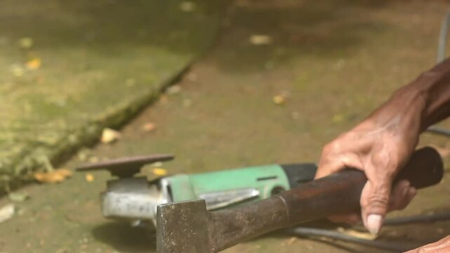 Isolated close up of chef knife sharpening, honing and stropping process by  a skilled craftsman. Vintage old school craftsman at work in grange shop showing true professional skills.
