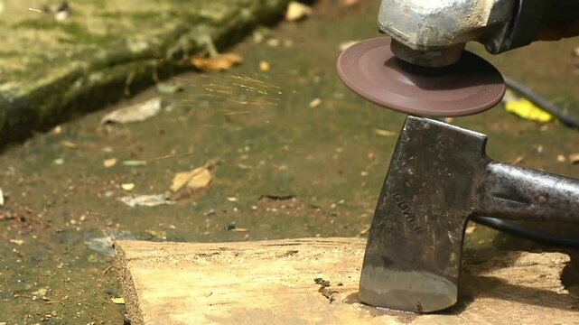Isolated close up of chef knife sharpening, honing and stropping process by  a skilled craftsman. Vintage old school craftsman at work in grange shop showing true professional skills.
