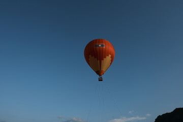 A hot air balloon is floating in the sky