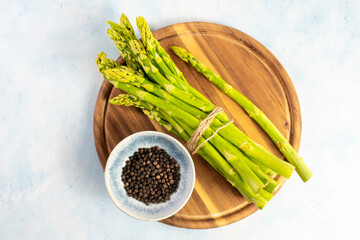 Green Asparagus on a wooden plate