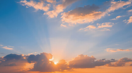 Fototapeta premium Breathtaking sunset sky with dramatic sun rays beaming through clouds. Soft orange, pink, and blue hues create a tranquil, inspiring, and peaceful background.