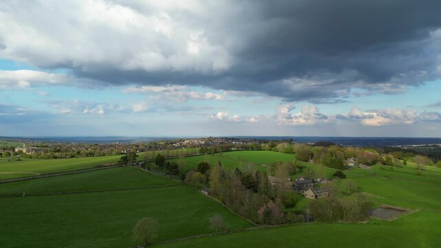 High Angle View of British Agricultural Farms at Countryside and Beautiful Landscape of Near Hills of Rotherham, England Great Britain of UK. April 30th, 2024.  Drone's Camera Footage