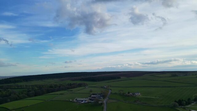 High Angle View of British Agricultural Farms at Countryside and Beautiful Landscape of Near Hills of Rotherham, England Great Britain of UK. April 30th, 2024.  Drone's Camera Footage