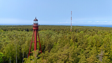 Ruhnu Island features a historic lighthouse amidst lush green forests and coastal views