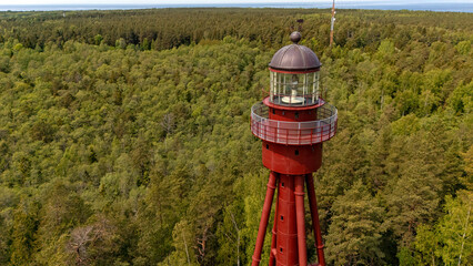 Exploration of the historic Ruhnu lighthouse in Estonia surrounded by lush greenery