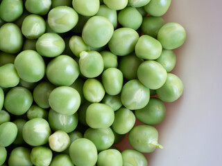 heap of peas in the white plate with copy space