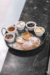 Pancake Breakfast Tray with Chocolate, Banana, Honey, Jam, and Cream-Pancake Brunch with Mixed Sweet Sauces and Fruit Garnish