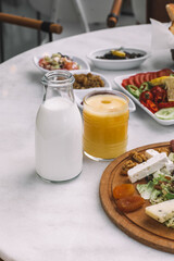 Milk Bottle and Glass of Orange Juice on Breakfast Table-Natural Dairy and Fruit Juice for Morning Meal-
