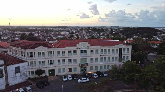Aerial view of the iconic city of Olinda in Pernambuco, Brazil with its 17th century buildings on cobblestone streets at sunset.