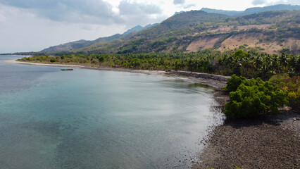 Obraz premium Scenic aerial view of ocean coastline with mangroves on tropical island of Atauro in Timor-Leste, Southeast Asia