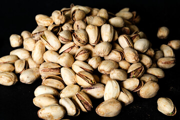 A Pile Or Group Of Healthy Salt and Pepper Pistachio Nuts In Their Shells