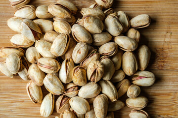 A Pile Or Group Of Healthy Salt and Pepper Pistachio Nuts In Their Shells