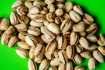 A Pile Or Group Of Healthy Salt and Pepper Pistachio Nuts In Their Shells