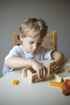 little boy playing with blocks